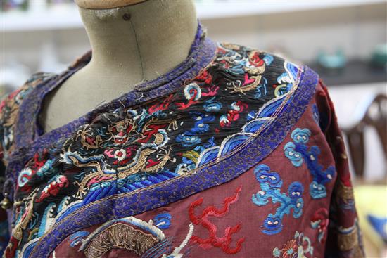 A Chinese claret satin embroidered silk and metal thread dragon robe, late Qing dynasty,